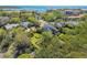 Stunning aerial view of a beautiful home with lush landscaping near the water at 1720 Mariner Way, Tarpon Springs, FL 34689