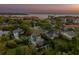 Picturesque aerial view of a neighborhood with a waterfront backdrop and lush greenery at 1720 Mariner Way, Tarpon Springs, FL 34689