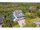 Stunning aerial view of a coastal home with a pool and lush greenery at 1720 Mariner Way, Tarpon Springs, FL 34689