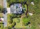 Aerial shot of the home, backyard, and lush landscaping with a creek behind the property at 1720 Mariner Way, Tarpon Springs, FL 34689