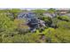 Aerial view of the home's back exterior featuring multiple decks and outdoor playground at 1720 Mariner Way, Tarpon Springs, FL 34689