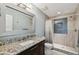 Beautiful bathroom features a granite countertop, oversized mirror, and glass enclosed shower with tiled walls at 1720 Mariner Way, Tarpon Springs, FL 34689