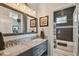 Elegant bathroom with a double vanity, tiled backsplash, stylish mirrors, and a separate water closet with tub at 1720 Mariner Way, Tarpon Springs, FL 34689