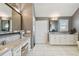 This bathroom features marble countertops, dual sinks, and a dedicated vanity area at 1720 Mariner Way, Tarpon Springs, FL 34689