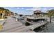 View of the community dock with multiple boats and nearby buildings under a partly cloudy sky at 1720 Mariner Way, Tarpon Springs, FL 34689