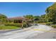 Gated community entrance with well-manicured landscaping, offering security and curb appeal at 1720 Mariner Way, Tarpon Springs, FL 34689