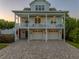 Charming two-story home with a large driveway, featuring a double balcony, three-car garage and lush landscaping at 1720 Mariner Way, Tarpon Springs, FL 34689