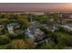 Aerial view of a waterfront home featuring a two-story layout, multiple balconies, screen enclosed pool and a lush backyard at 1720 Mariner Way, Tarpon Springs, FL 34689