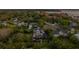 Aerial view of a waterfront home featuring a two-story layout, multiple balconies, screen enclosed pool and a lush backyard at 1720 Mariner Way, Tarpon Springs, FL 34689