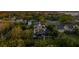 Aerial view of a charming two-story home with balconies, pool, and playground amidst lush greenery and a waterfront view at 1720 Mariner Way, Tarpon Springs, FL 34689