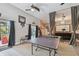 Spacious game room with ping pong table, custom curtains, and cozy seating area with entertainment setup at 1720 Mariner Way, Tarpon Springs, FL 34689