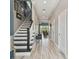 Elegant hallway featuring hardwood floors, staircase, and access to living areas at 1720 Mariner Way, Tarpon Springs, FL 34689
