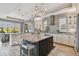 Spacious kitchen with an island, granite countertops, pendant lighting, and stainless steel appliances at 1720 Mariner Way, Tarpon Springs, FL 34689