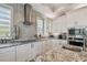 Modern kitchen with stainless steel appliances, sleek countertops, and herringbone backsplash at 1720 Mariner Way, Tarpon Springs, FL 34689