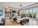 Stylish living room featuring modern decor, fireplace, built-ins, and sliding glass doors to the outside deck at 1720 Mariner Way, Tarpon Springs, FL 34689