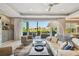 Bright living room with modern decor, opening to a deck with scenic views; features a fireplace at 1720 Mariner Way, Tarpon Springs, FL 34689