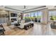 Bright living room boasts a stone fireplace, built-in shelving, and sliding glass doors to a deck at 1720 Mariner Way, Tarpon Springs, FL 34689