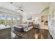 Spacious bedroom with patio doors, ensuite bath, ceiling fan, plush rug, and neutral tones for a relaxing retreat at 1720 Mariner Way, Tarpon Springs, FL 34689