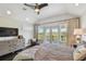 This primary bedroom features French doors to a private balcony and a ceiling fan at 1720 Mariner Way, Tarpon Springs, FL 34689