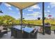 Relaxing outdoor patio with dining and lounging areas and stunning views of the surrounding landscape at 1720 Mariner Way, Tarpon Springs, FL 34689