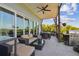 Spacious outdoor patio with seating and dining areas, complemented by views and a modern ceiling fan at 1720 Mariner Way, Tarpon Springs, FL 34689