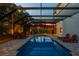 Inviting screened-in pool with lounge chairs and ample space for relaxation and outdoor entertainment at 1720 Mariner Way, Tarpon Springs, FL 34689