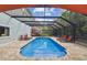 Enclosed swimming pool with an adjacent sundeck and lounge chairs for relaxation at 1720 Mariner Way, Tarpon Springs, FL 34689