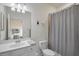 Bathroom featuring a single sink vanity and shower with neutral colored curtain at 17541 Timberline Pkwy, Punta Gorda, FL 33982