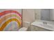Bathroom with a single sink vanity and rainbow shower curtain at 17541 Timberline Pkwy, Punta Gorda, FL 33982