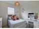Cozy bedroom with vanity and a natural woven light fixture at 17541 Timberline Pkwy, Punta Gorda, FL 33982
