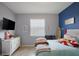Light-filled bedroom with decor, television, and bright accent wall at 17541 Timberline Pkwy, Punta Gorda, FL 33982