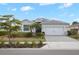 Charming single-story home with well-manicured landscaping, paved driveway, and two-car garage at 17541 Timberline Pkwy, Punta Gorda, FL 33982