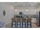 Open kitchen featuring a breakfast bar with seating, modern appliances, granite countertops, and ample storage at 17541 Timberline Pkwy, Punta Gorda, FL 33982