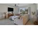 Comfortable living room featuring a large sectional sofa, TV, and big windows with outside scenery at 17541 Timberline Pkwy, Punta Gorda, FL 33982