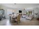 Open-concept living and dining area with tile floors, modern furnishings, and plenty of natural light at 17541 Timberline Pkwy, Punta Gorda, FL 33982
