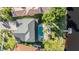 An aerial view shows the backyard pool and patio area with lake access at 17927 Bahama Isle Cir, Tampa, FL 33647