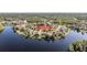 Aerial view showcases waterfront community with homes around a lake and canal at 17927 Bahama Isle Cir, Tampa, FL 33647