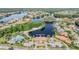 Aerial view showcasing a community, expansive lake and lakeside amenities at 17927 Bahama Isle Cir, Tampa, FL 33647