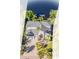 Aerial view of a two-story home with lush landscaping and a driveway at 17927 Bahama Isle Cir, Tampa, FL 33647