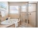 Bathroom featuring a large soaking tub and separate shower with glass door at 17927 Bahama Isle Cir, Tampa, FL 33647
