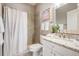 Clean bathroom featuring stone counters, a shower-tub combo with neutral tile, and a vanity with drawers at 17927 Bahama Isle Cir, Tampa, FL 33647