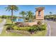 Community entrance featuring manicured landscaping, a tranquil lake, and a welcoming gatehouse at 17927 Bahama Isle Cir, Tampa, FL 33647