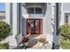 Elegant front entrance with double red doors, decorative wreath, and stone accents at 17927 Bahama Isle Cir, Tampa, FL 33647