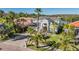 A lovely two-story home with a gray exterior, lush landscaping, and a paved driveway at 17927 Bahama Isle Cir, Tampa, FL 33647