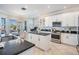 Open kitchen boasts stainless appliances, granite counters, tile flooring, and a breakfast nook at 17927 Bahama Isle Cir, Tampa, FL 33647