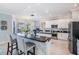 Open concept kitchen features an island with bar seating, sleek appliances, and granite counters at 17927 Bahama Isle Cir, Tampa, FL 33647