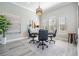 Bright office space with wood floors, a modern chandelier, and three large windows at 17927 Bahama Isle Cir, Tampa, FL 33647