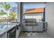 Outdoor kitchen area features stainless steel appliances and granite countertops, perfect for outdoor entertaining at 17927 Bahama Isle Cir, Tampa, FL 33647