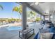 Relaxing outdoor patio with a seating area overlooking the pool and lake at 17927 Bahama Isle Cir, Tampa, FL 33647