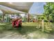 Playground with soft turf, playground equipment, and shade canopies at 17927 Bahama Isle Cir, Tampa, FL 33647